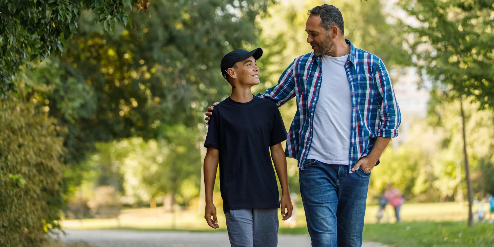A father walking with his teenage son