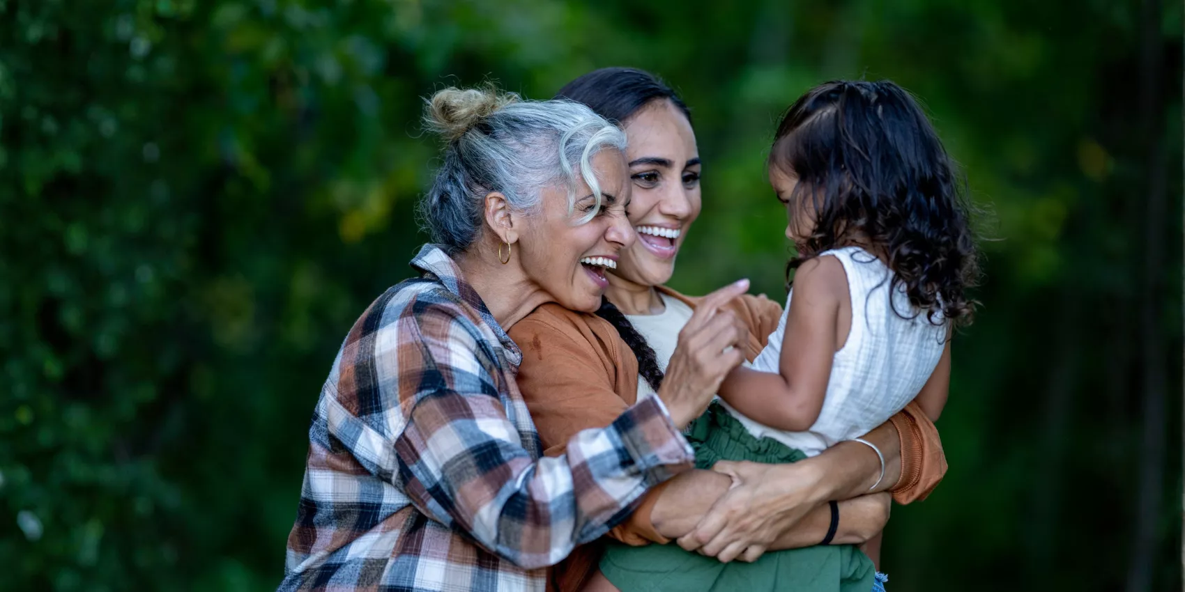 Grandmother, mother and young child enjoying time together outdoors